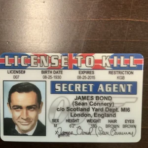 BOND James Bond license to kill card with red-white border, black hair silhouette, and “SECRET AGENT” text.