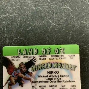 Green Nikko from Oz card with winged monkey, rainbow text, and “Land of Oz” banner.